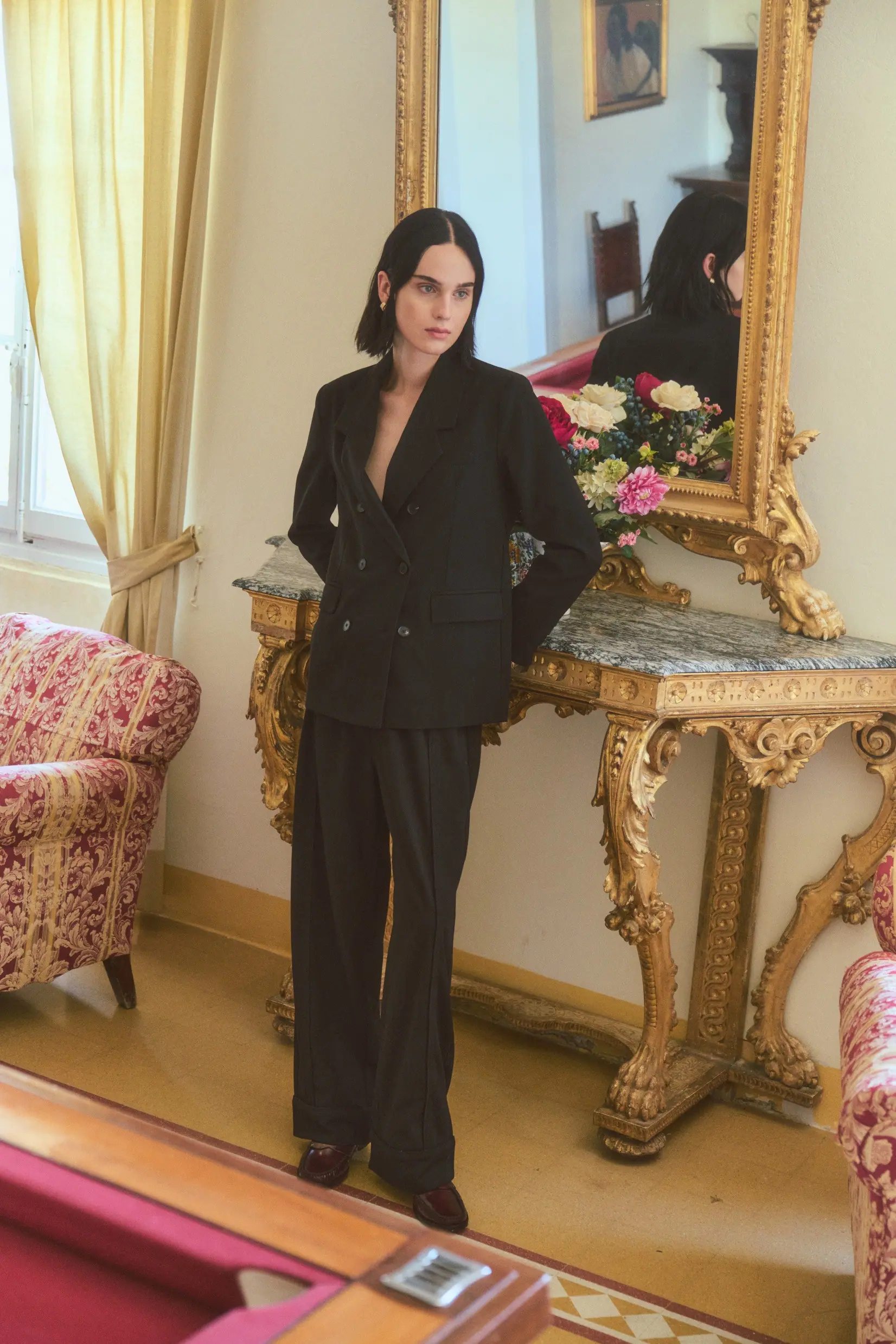 A woman turning in soft daylight, fabric in fluid drape.