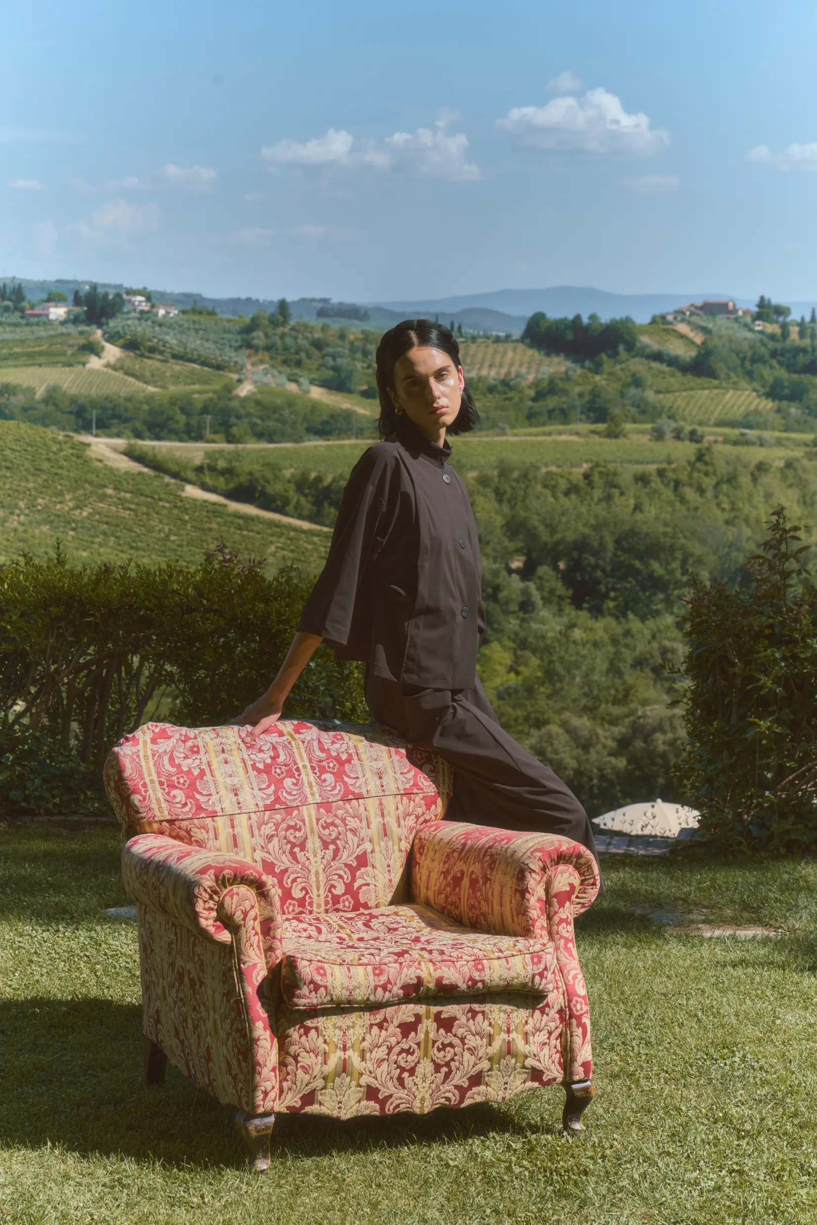 A full-length portrait of the woman in tailored autumn dress, presented like a print plate.