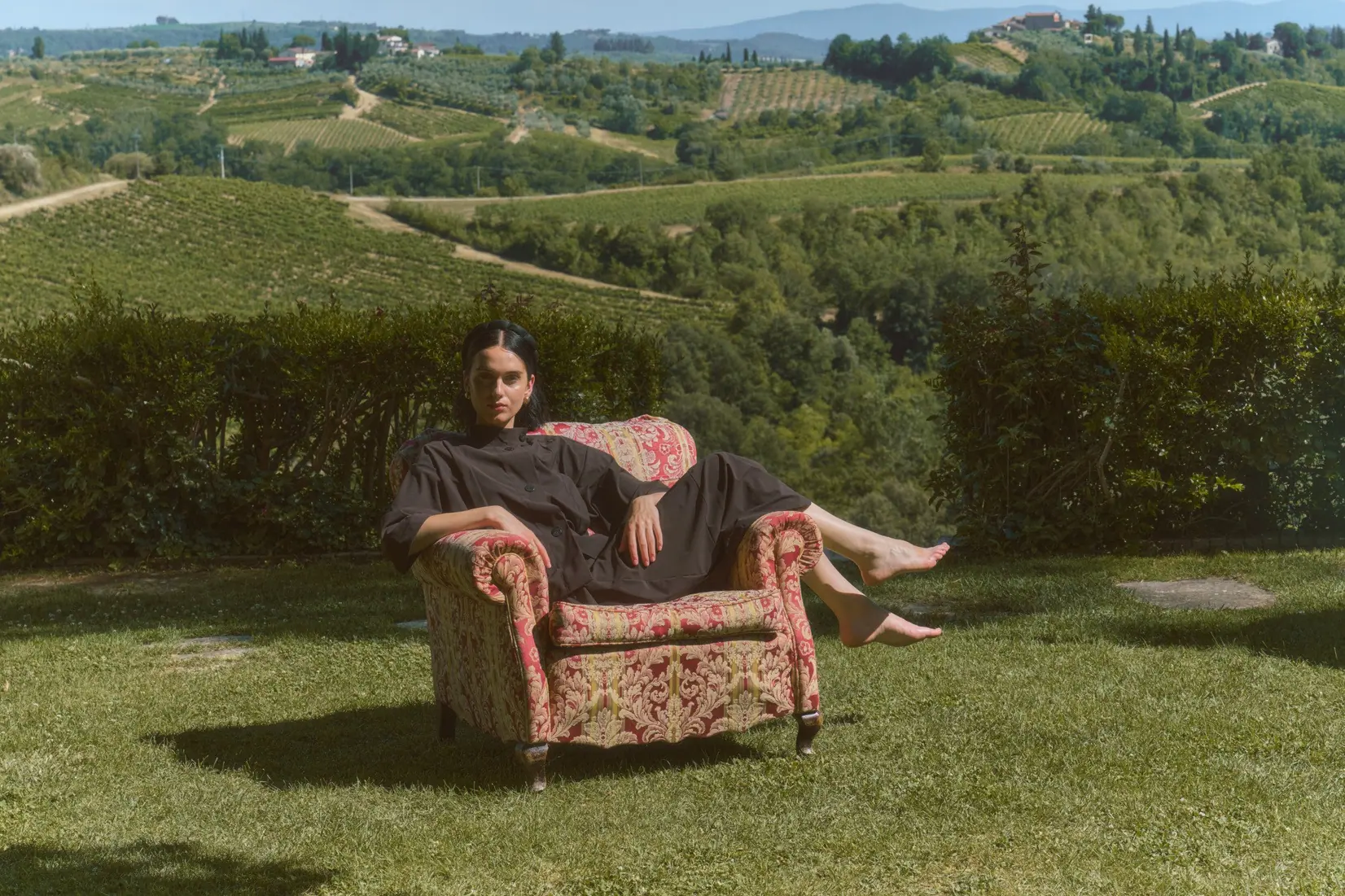 A quiet, wide view of a Tuscan villa interior bathed in summer light.
